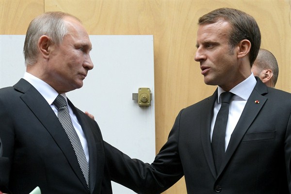 French President Emmanuel Macron, right, and Russian President Vladimir Putin talk after a service for late French President Jacques Chirac, in Paris, Sept. 30, 2019 (pool photo by Alexei Druzhinin of Sputnik via AP Images).