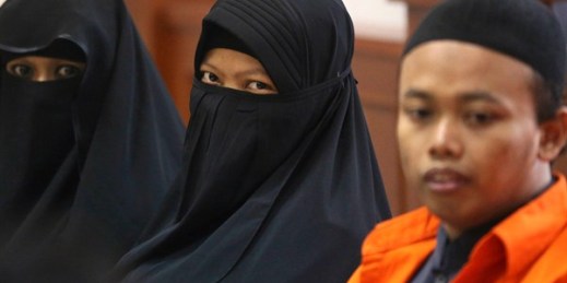 Dian Novi, center, flanked by her husband, Nur Solihin, during a trial against them for
planning a suicide bombing, Jakarta, Indonesia, Aug. 23, 2017 (AP photo by Achmad Ibrahmin).