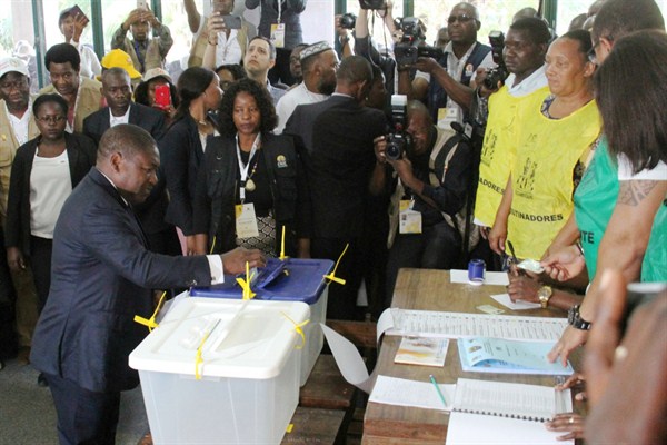 Mozambican President Felipe Nyusi, bottom left, casts his vote in the country’s presidential election, in Maputo, Mozambique (AP photo by Ferhat Momade).