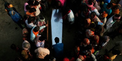 Relatives and villagers gather around the coffin of Balkisun Mandal Khatwe, a Nepalese migrant worker who died while working on a Qatari construction project, Belhi, Nepal, Nov. 23, 2016 (AP photo by Niranjan Shrestha).
