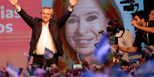 Argentine President-elect Alberto Fernandez waves to supporters, standing in front of an image of his running-mate, Cristina Fernandez de Kirchner, on Election Day in Buenos Aires, Oct. 27, 2019 (AP photo by Daniel Jayo).
