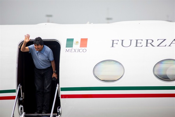 Former Bolivian President Evo Morales waves as he gets out of a Mexican Air Force plane in Mexico City (Photo by Jair Cabrera Torres for dpa via AP Images).