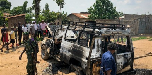 Congolese security forces attend to the scene after the vehicle of an Ebola response team was attacked and burned in Beni, northeastern Congo, June 24, 2019 (AP photo by Al-hadji Kudra Maliro).