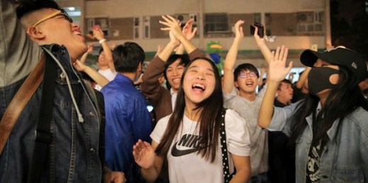 Pro-democracy supporters celebrate after pro-Beijing politician Junius Ho lost his election in Hong Kong, Nov. 25, 2019 (AP photo by Kin Cheung).