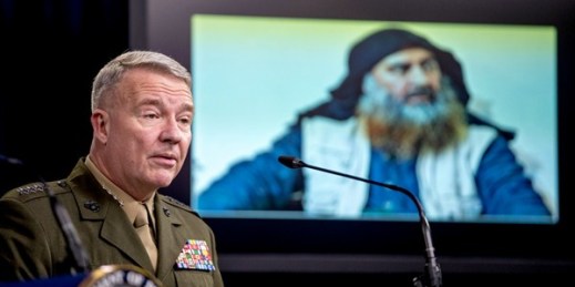 A photo of Abu Bakr al-Baghdadi is displayed on a monitor as U.S. Central Command Commander Marine Gen. Kenneth McKenzie speaks at a joint press briefing at the Pentagon in Washington, Oct. 30, 2019 (AP photo by Andrew Harnik).