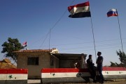Syrian and Russian flags fly at a checkpoint of a so-called de-escalation zone near Homs, Syria, Sept. 13, 2017 (AP file photo by Nataliya Vasilyeva).