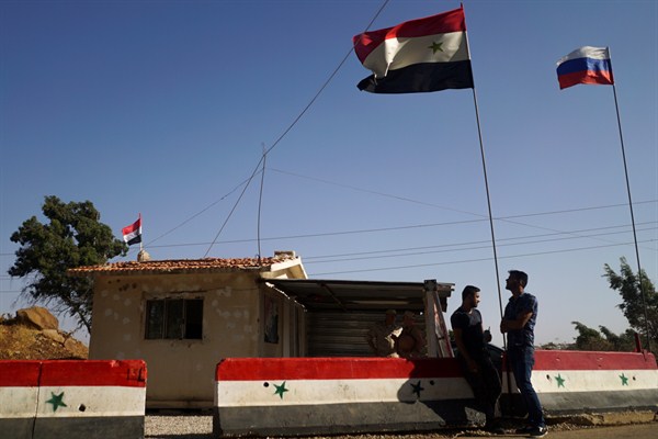 Syrian and Russian flags fly at a checkpoint of a so-called de-escalation zone near Homs, Syria, Sept. 13, 2017 (AP file photo by Nataliya Vasilyeva).