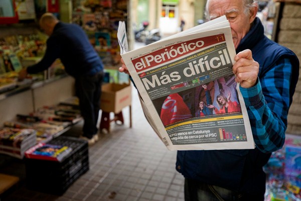 A man reads a newspaper with the headline “More Difficult,” following the recent elections, Barcelona, Spain, Nov. 11, 2019 (AP photo by Emilio Morenatti).