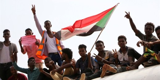 Sudanese pro-democracy supporters celebrate a final power-sharing agreement with the ruling military council, Khartoum, Aug. 17, 2019 (AP photo by Mahmoud Hjaj).