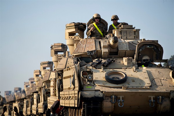 Bradley Infantry Fighting Vehicles from the U.S. Army's 1st Armored Battalion on rail cars ahead of the Atlantic Resolve military exercise outside Vilnius, Lithuania, Oct. 21, 2019 (AP photo by Mindaugas Kulbis).