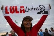 A supporter of former Brazilian President Luiz Inacio Lula da Silva holds a poster that says in Portuguese “Free Lula,” Brasilia, Brazil, June 25, 2019 (AP photo by Eraldo Peres).