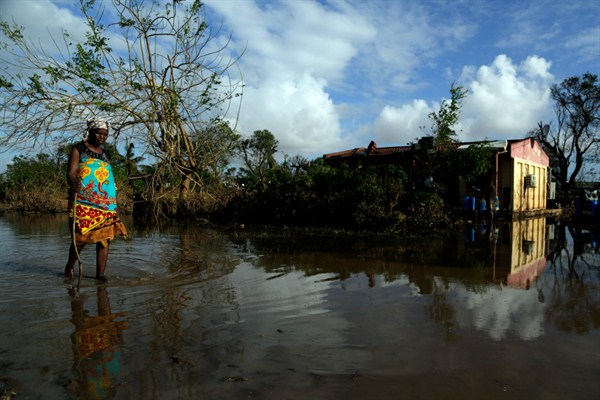 A woman walks along a flooded road in Buzi district, outside Beira, Mozambique, March 23, 2019 (AP photo by Themba Hadebe).