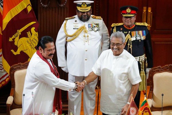 Sri Lanka's new president, Gotabaya Rajapaksa, right, greets his brother Mahinda after appointing him prime minister at the presidential secretariat in Colombo, Nov. 21, 2019 (AP photo by Eranga Jayawardena).