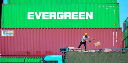 A worker loads imported goods on a truck at a distribution company outside the container port in Qingdao, China, Oct. 14, 2019 (Chinatopix photo via AP Images).