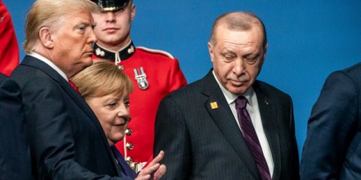 Turkish President Recep Tayyip Erdogan, right, with German Chancellor Angela Merkel and President Donald Trump at the NATO summit in London, Dec. 4, 2019 (Photo by Michael Kappeler for dpa via AP Images).
