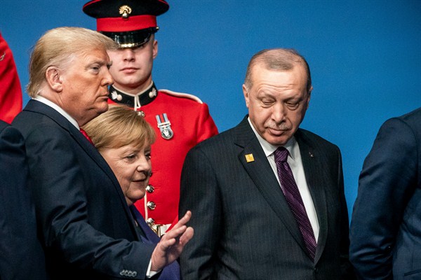 Turkish President Recep Tayyip Erdogan, right, with German Chancellor Angela Merkel and President Donald Trump at the NATO summit in London, Dec. 4, 2019 (Photo by Michael Kappeler for dpa via AP Images).