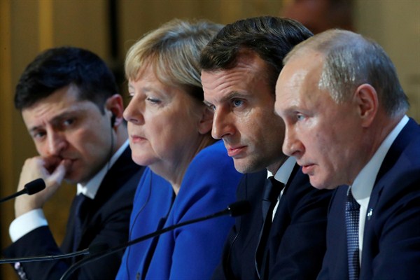 From left, Ukrainian President Volodymyr Zelensky, German Chancellor Angela Merkel, French President Emmanuel Macron and Russian President Vladimir Putin at a joint news conference in Paris, Dec. 9, 2019 (pool photo by Charles Platiau of Reuters via AP).