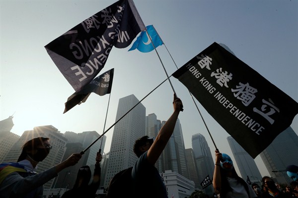 People hold flags during a rally to show support for China’s Uighur Muslims, in Hong Kong,  Dec. 22, 2019 (AP photo by Lee Jin-man).