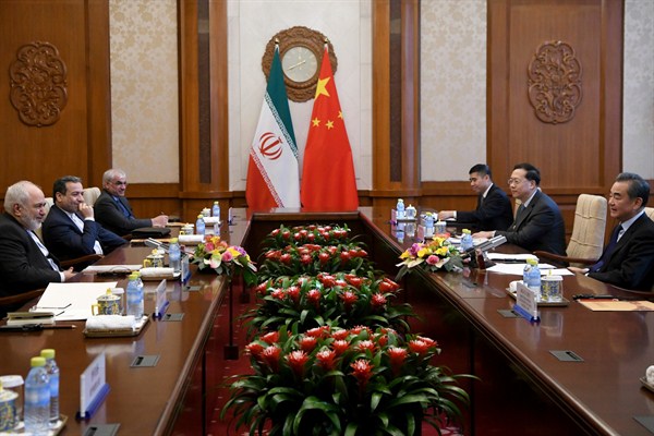 Chinese Foreign Minister Wang Yi, right, talks to Iranian Foreign Minister Mohammad Javad Zarif, left, during a meeting in Beijing, Dec. 31, 2019 (pool photo by Noel Celis of AFP via AP Images).