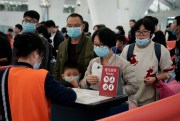 Passengers in masks at Hong Kong’s high speed train station, Jan. 22, 2020 (AP photo by Kin Cheung).