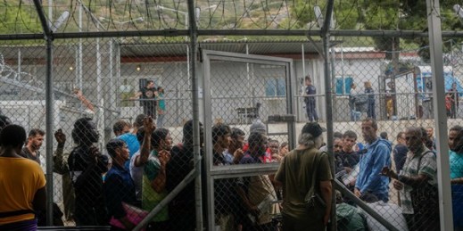 Refugees and migrants wait outside the information office at a refugee camp on the Greek island of Samos, Sept. 25, 2019 (AP photo by Petros Giannakouris).