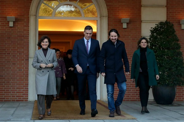 Spanish Prime Minister Pedro Sanchez, second left, walks next to Podemos leader Pablo Iglesias, second right, and First Deputy Prime Minister Carmen Calvo, left, at the Moncloa Palace in Madrid, Spain, Jan. 14, 2020 (AP photo by Manu Fernandez).