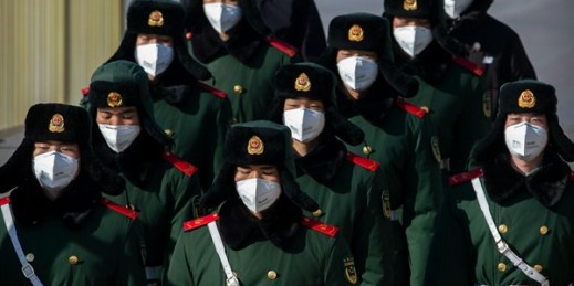 Paramilitary policemen wear face masks as they march in formation near Tiananmen Square, Beijing, Feb. 4, 2020 (AP photo by Mark Schiefelbein).