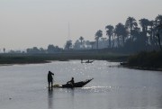 Men fish in boats on the Nile river, Manfalut, Egypt, Jan. 29, 2020 (Photo by Lobna Tarek for dpa via AP Images).