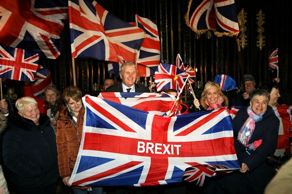 Brexit supporters celebrate the U.K.’s official exit from the European Union, at a rally outside Stormont, the seat of the Northern Ireland Assembly in Belfast, Jan. 31, 2020 (AP photo by Peter Morrison).