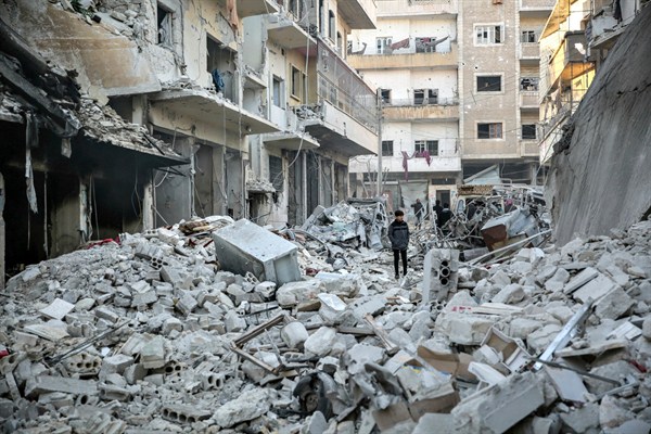 People inspect damaged buildings following three airstrikes allegedly carried out by Russian warplanes targeting the Shami Hospital in rebel-held Idlib province, Syria, Jan. 30, 2020 (DPA photo by Anas Alkharboutli via AP Images).
