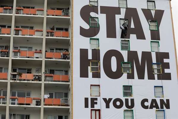 A billboard is installed on an apartment building in Cape Town, South Africa, March 25, 2020 (AP photo by Nardus Engelbrecht).