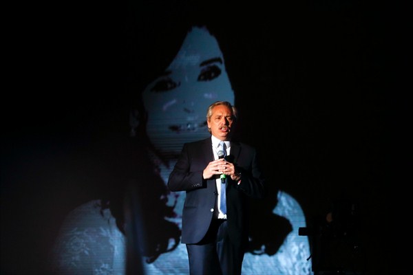Argentine President Alberto Fernandez speaks to supporters as Vice President Cristina Fernandez de Kirchner is projected on a screen behind him outside the presidential palace in Buenos Aires, Argentina, Dec. 10, 2019 (AP photo by Natacha Pisarenko).