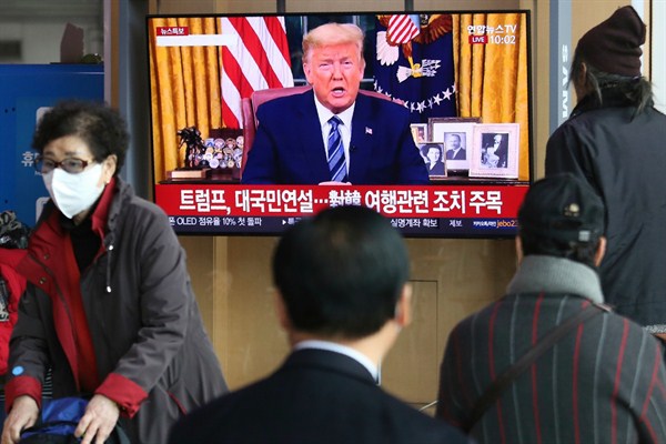 People watch a TV showing a live broadcast of U.S. President Donald Trump’s speech at the Seoul Railway Station in Seoul, South Korea, March 12, 2020 (AP photo by Ahn Young-joon).