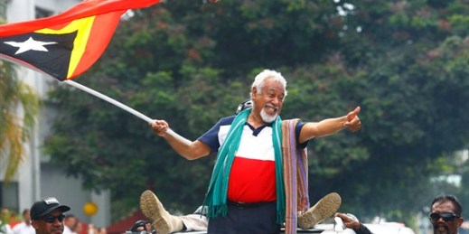 East Timorese independence hero Xanana Gusmao, center, waves a national flag in Dili, East Timor, March 11, 2018 (AP photo by Valentino Darriel).