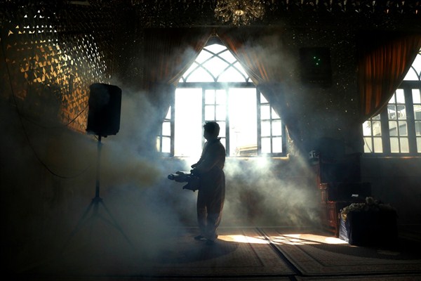 A firefighter disinfects the shrine of Saint Saleh to help prevent the spread of the novel coronavirus in Tehran, Iran, March, 6, 2020 (AP photo by Ebrahim Noroozi).