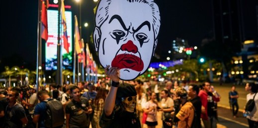 A protester holds a cut-out of the new prime minister, Muhyiddin Yassin, in Kuala Lumpur, Malaysia, Feb. 29, 2020 (AP photo by Vincent Thian).
