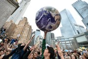 A student protester holds up a foam replica of the earth during the Youth Climate Strike at Columbus Circle in New York City, March 15, 2019 (Sipa photo by Anthony Behar via AP Images).