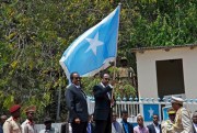 Somali President Mohamed Abdullahi Mohamed holds a national flag during a handover ceremony at the presidential palace in Mogadishu, Somalia, Feb. 16, 2017 (AP photo by Farah Abdi Warsameh).