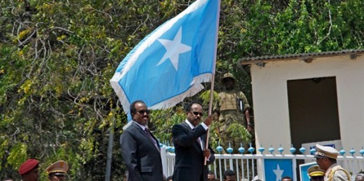 Somali President Mohamed Abdullahi Mohamed holds a national flag during a handover ceremony at the presidential palace in Mogadishu, Somalia, Feb. 16, 2017 (AP photo by Farah Abdi Warsameh).