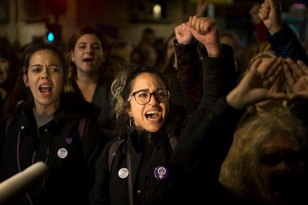 Women protest outside the Justice Ministry after five men accused of gang raping an unconscious 14-year-old three years ago were convicted of sexual abuse instead of assault or rape, in Madrid, Spain, Nov. 4, 2019 (AP photo by Paul White).