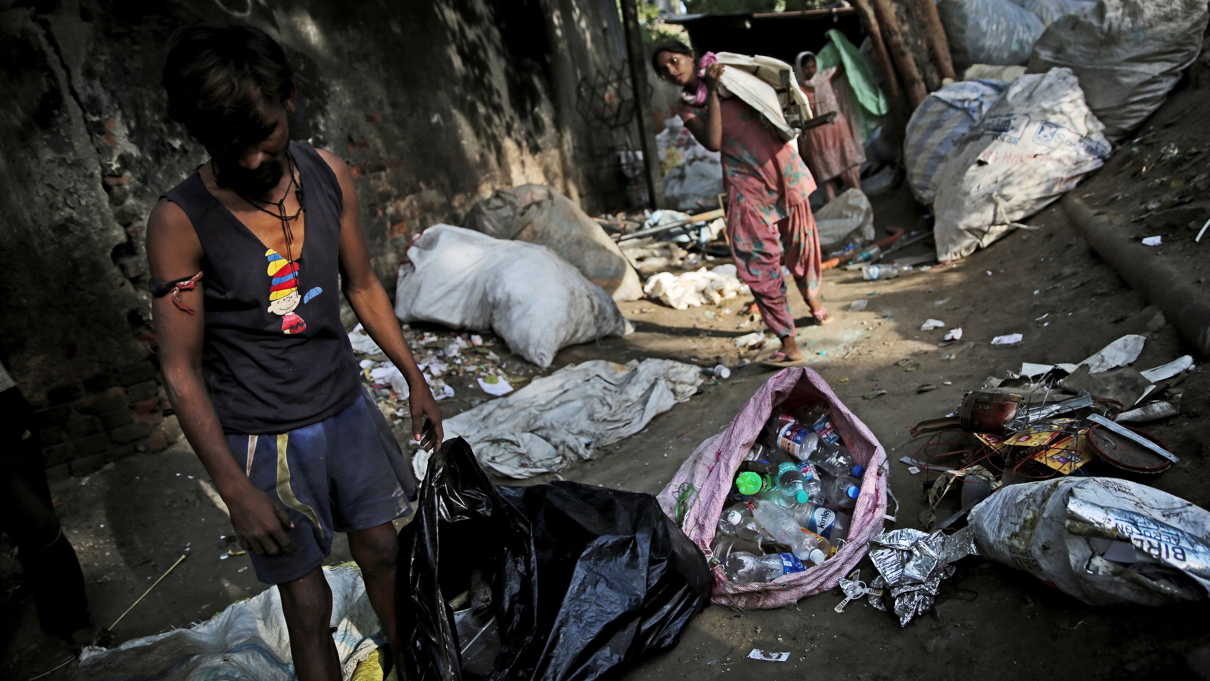 新德里的垃圾收集者捡起塑料瓶