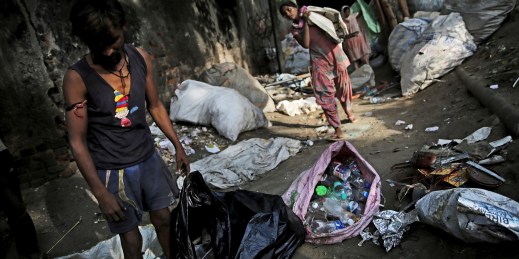 Trash collectors pick up plastic bottles in New Delhi