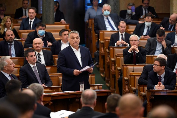 Hungarian Prime Minister Viktor Orban, center, delivers a speech about the coronavirus outbreak at the House of Parliament in Budapest, March 23, 2020 (MTI photo by Tamas Kovacs via AP Images).
