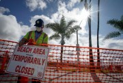 A city worker closes an area of Newport Beach in California, United States, April 10, 2020 (AP photo by Chris Carlson).