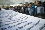 Demonstrators hold a banner with the names of murdered activists during a protest march in Bogota, Colombia, July 26, 2019 (AP photo by Ivan Valencia).