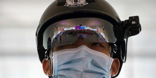 A police officer wearing a face mask at Wuhan Tianhe International Airport in Wuhan, Hubei Province, China, April 8, 2020 (AP photo by Ng Han Guan).
