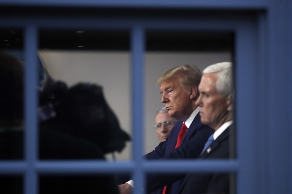 President Donald Trump and Vice President Mike Pence listen to a briefing about the coronavirus at the White House in Washington, March 31, 2020 (AP photo by Alex Brandon).