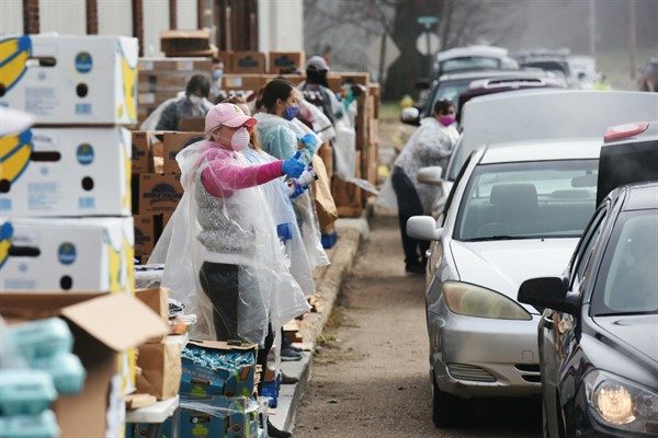 Volunteers distribute food to hundreds of families in Benton Harbor, Michigan, April 2, 2020 (Photo by Don Campbell for The Herald-Palladium via AP Images).