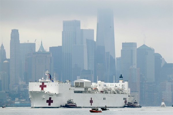 The Navy hospital ship USNS Comfort passes lower Manhattan on its way to docking in New York, March 30, 2020 (AP Photo by Seth Wenig).