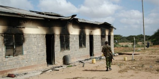A member of Kenya’s security forces walks past a damaged police post after an attack by al-Shabab in the settlement of Kamuthe, Garissa county, Kenya, Jan. 13, 2020 (AP photo).